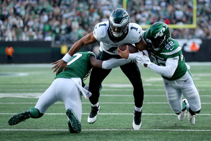 Philadelphia Eagles quarterback Jalen Hurts (1) is tackled by New York Jets cornerback Bryce Hall (37) and safety Tony Adams (22) during the first quarter at MetLife Stadium.